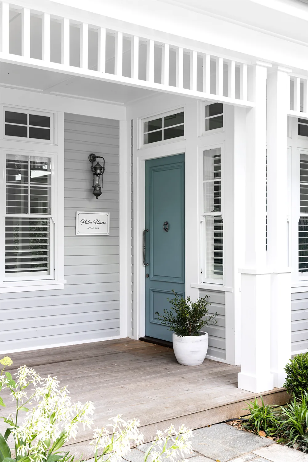Hamptons style home entrance with plae blue front door