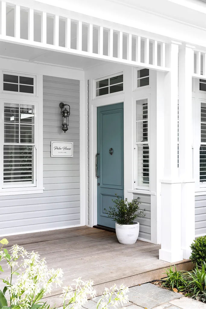 Hamptons style home entrance with plae blue front door
