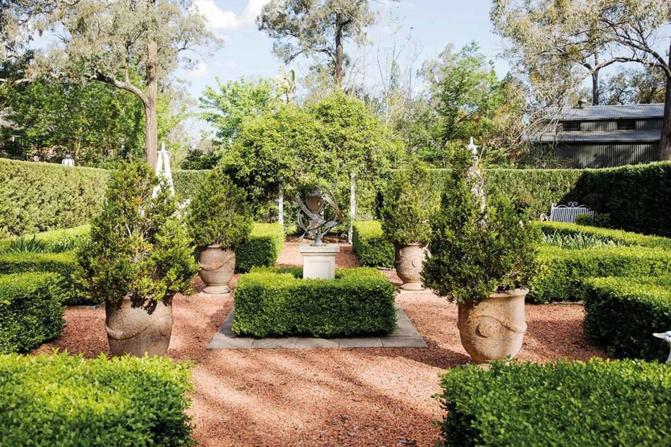 Hamptons style formal garden with hedges and terracotta pots