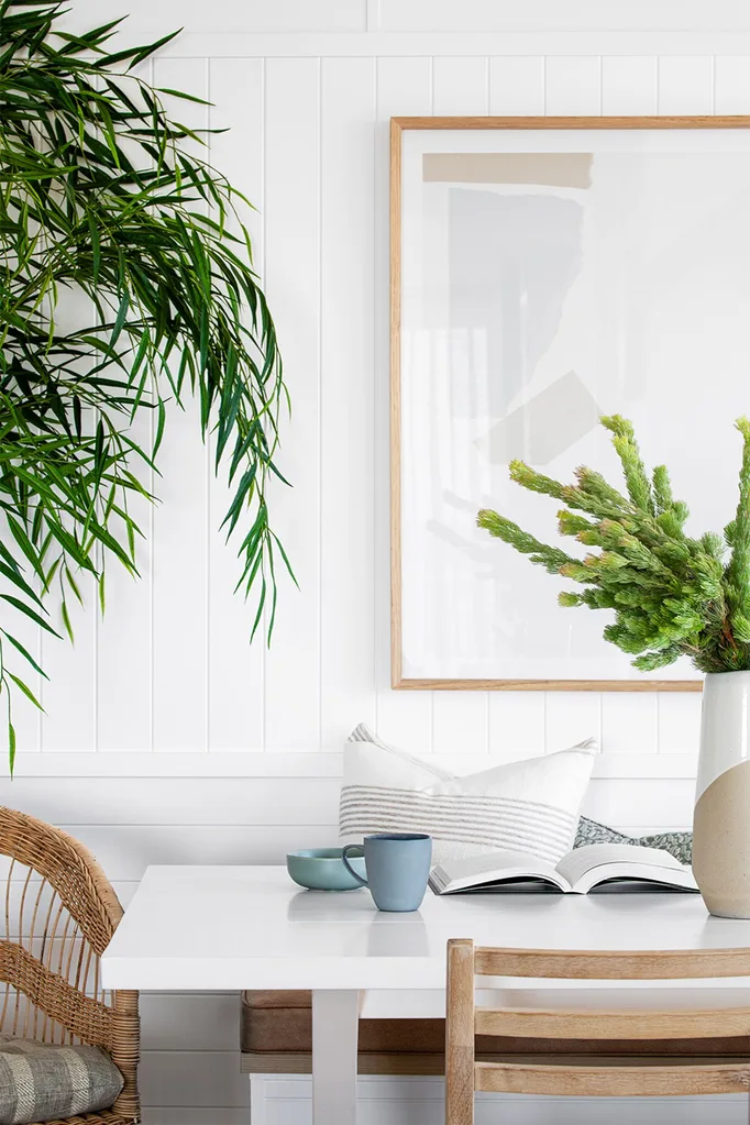 dining-table-nook-white-walls-rattan-chair