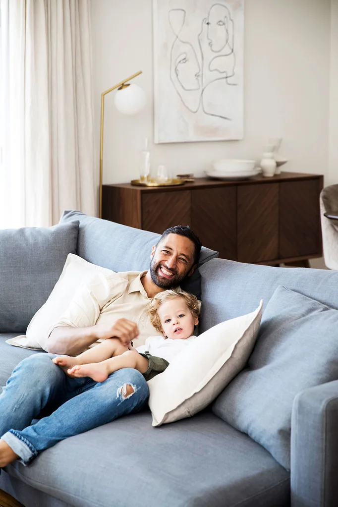 Benji Marshall on sofa with son