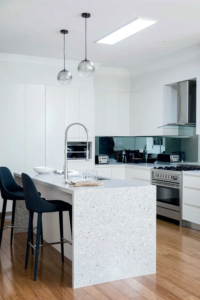 Modern kitchen with tinted mirror splashback