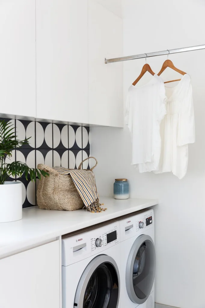 White laundry with t-shirts hung on rail