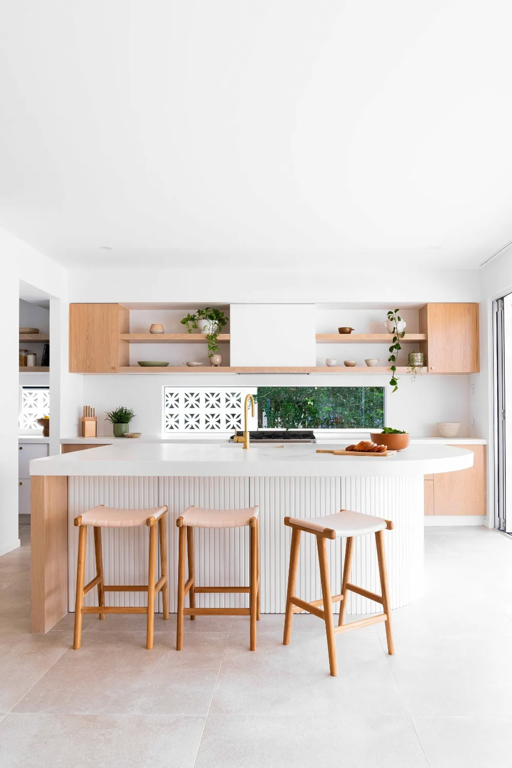 Coastal home with curved kitchen island bench