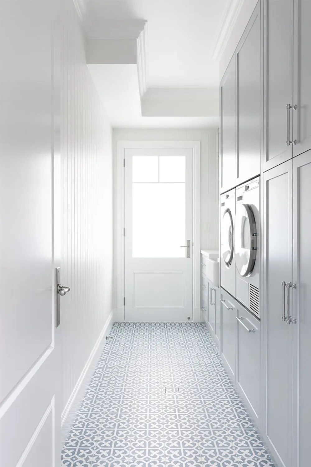 White Hamptons laundry with statement floor tile