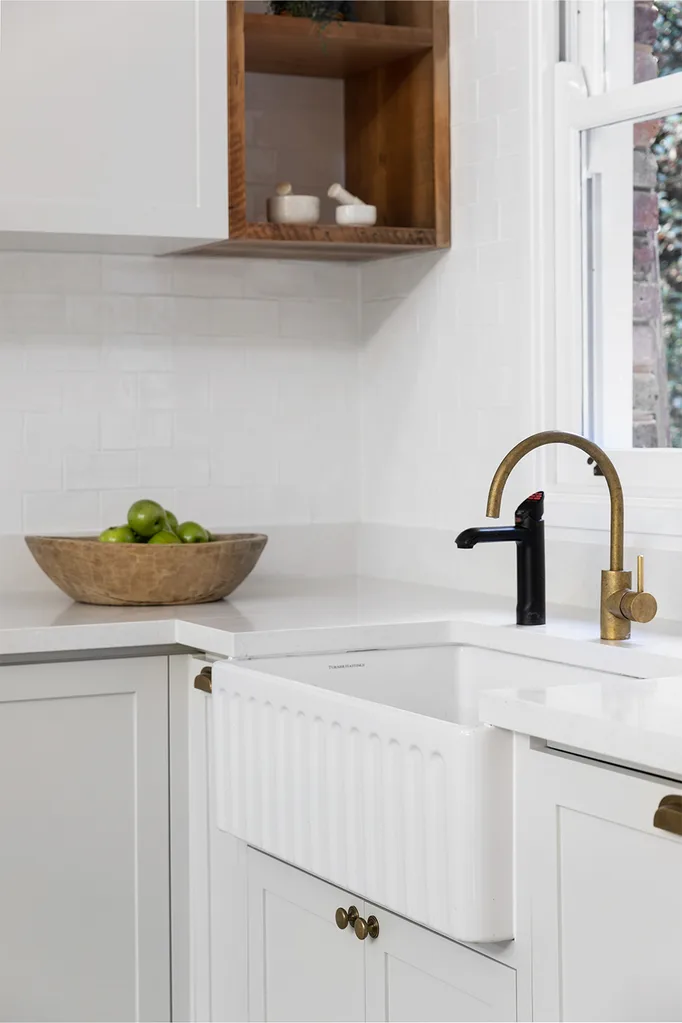 fluted farmhouse sink with brass sink mixer and zip tap