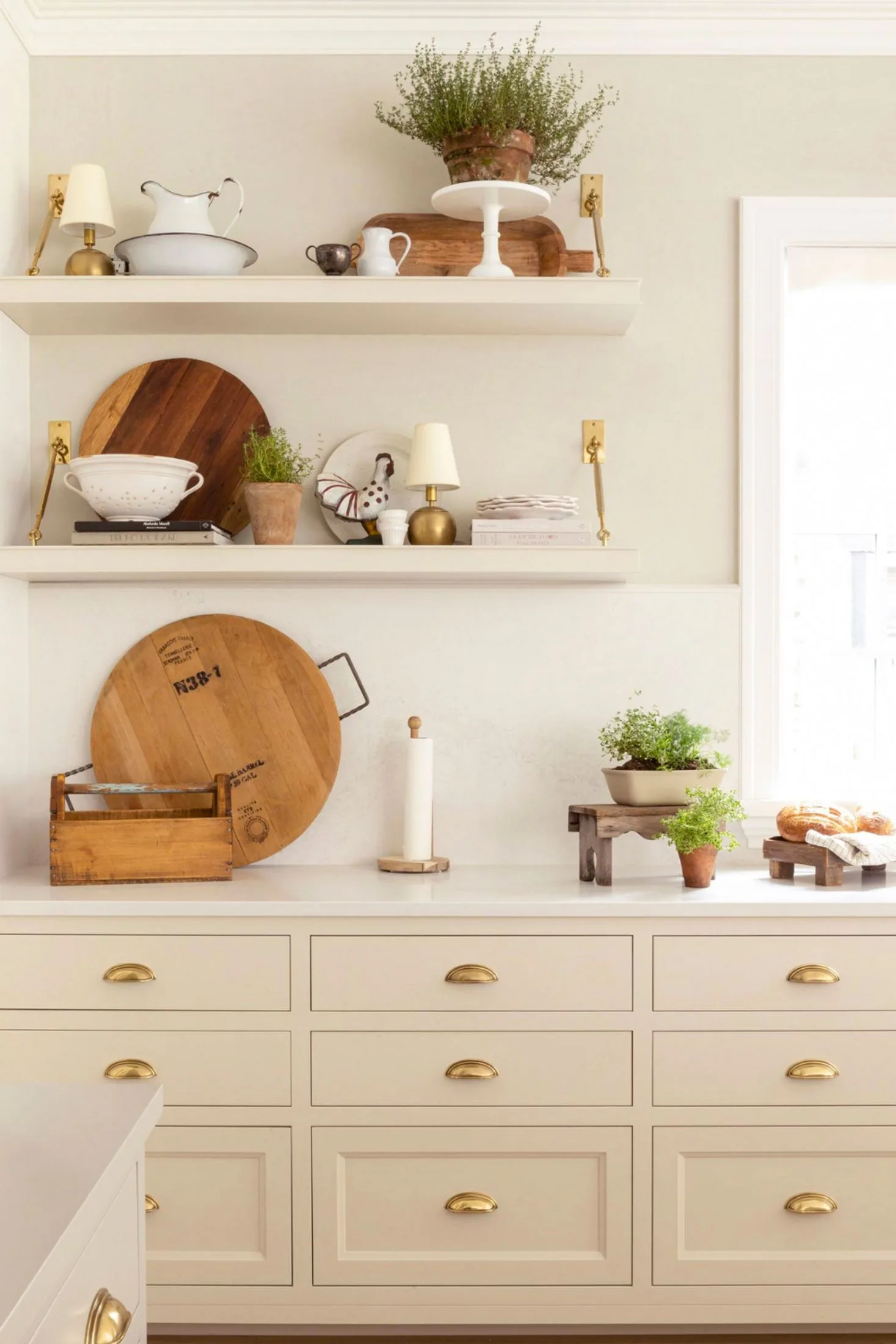 Open shelves and gold drawer pulls in kitchen