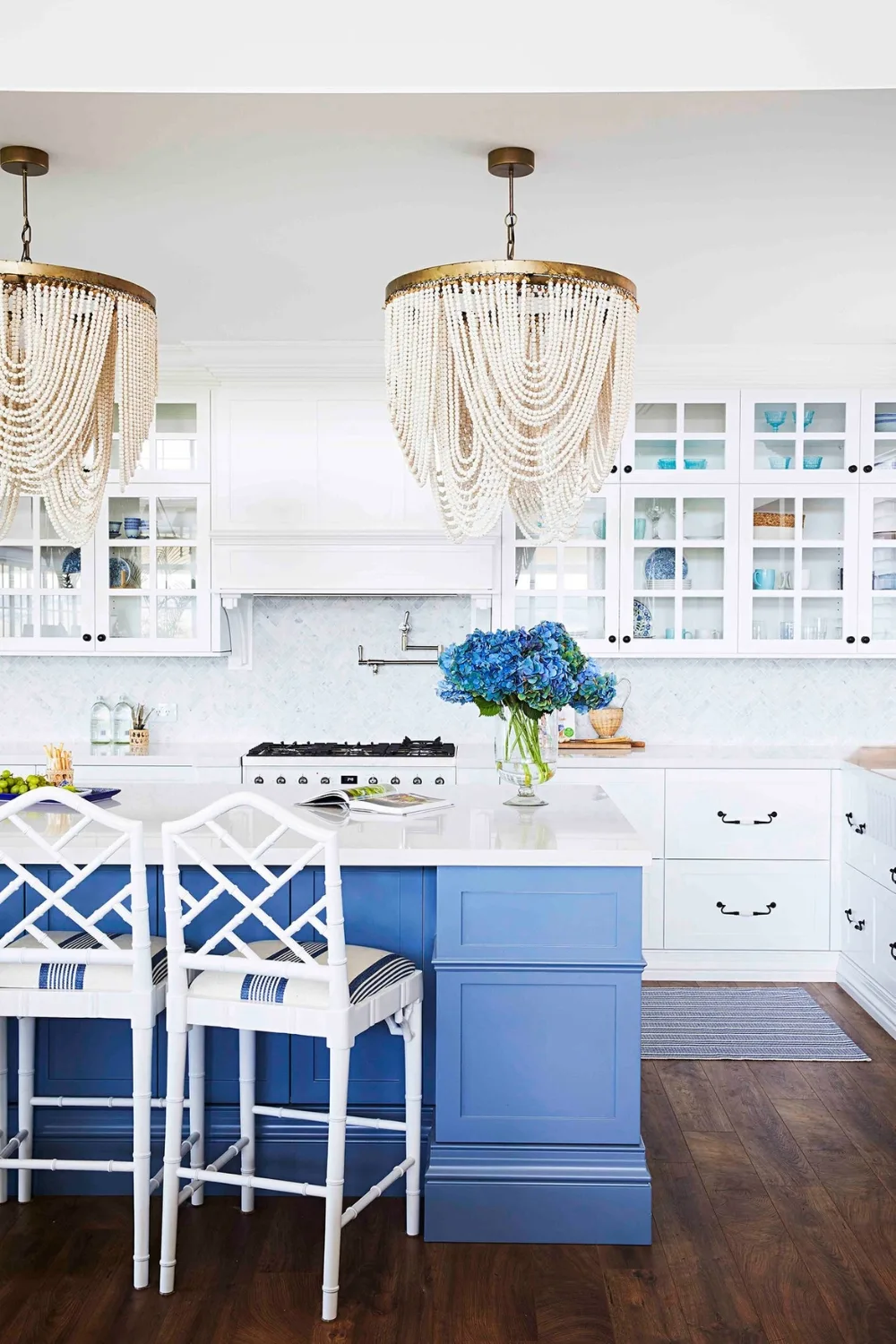 Glamorous Hamptons style kitchen with blue island bench