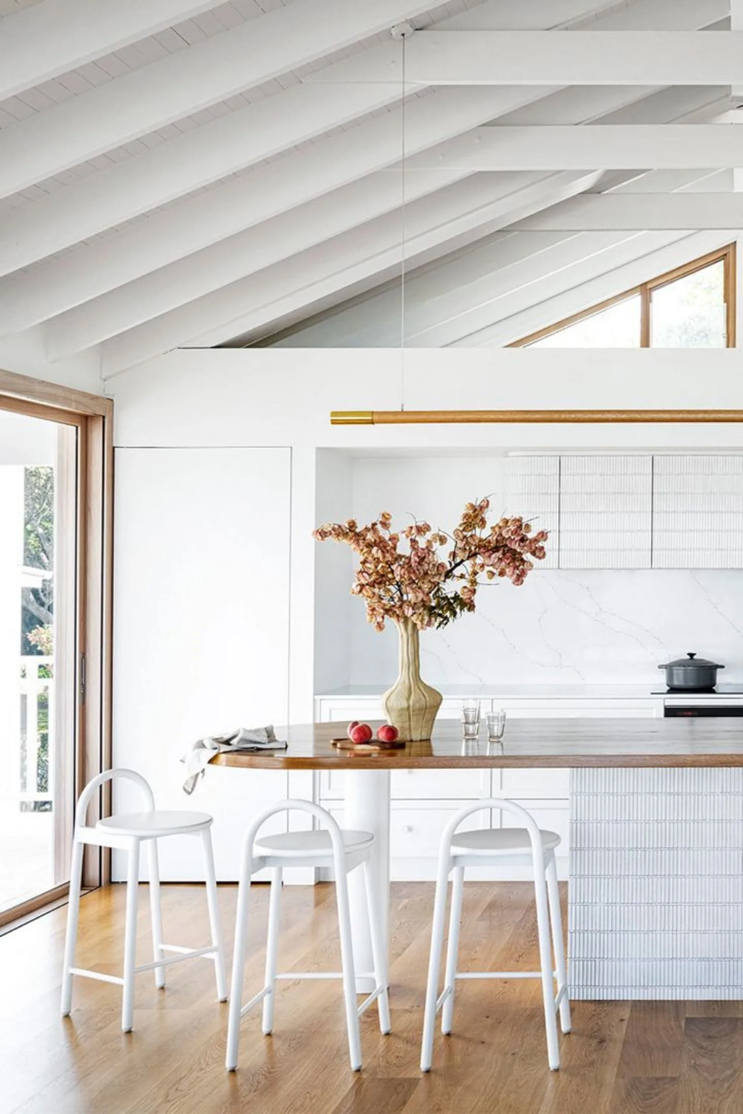 White modern coastal kitchen with curved island bench