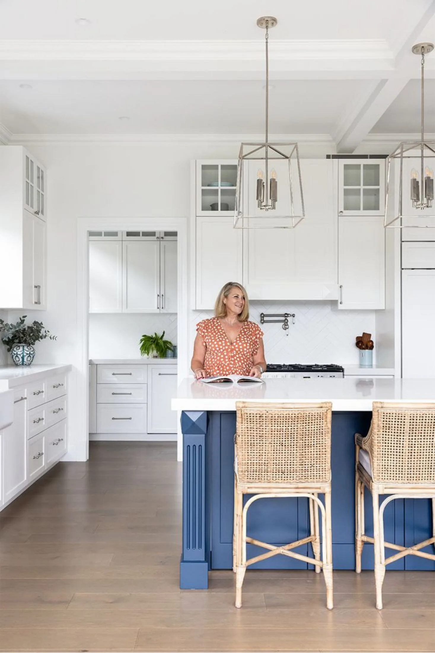 White Hamptons style kitchen with blue island bench