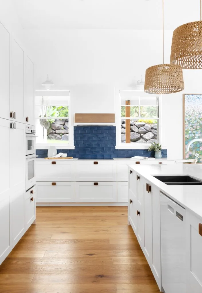 white kitchen timber floorboard rattan pendant lights