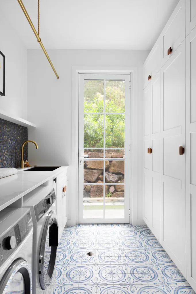 Hamptons laundry with blue patterned floor tiles