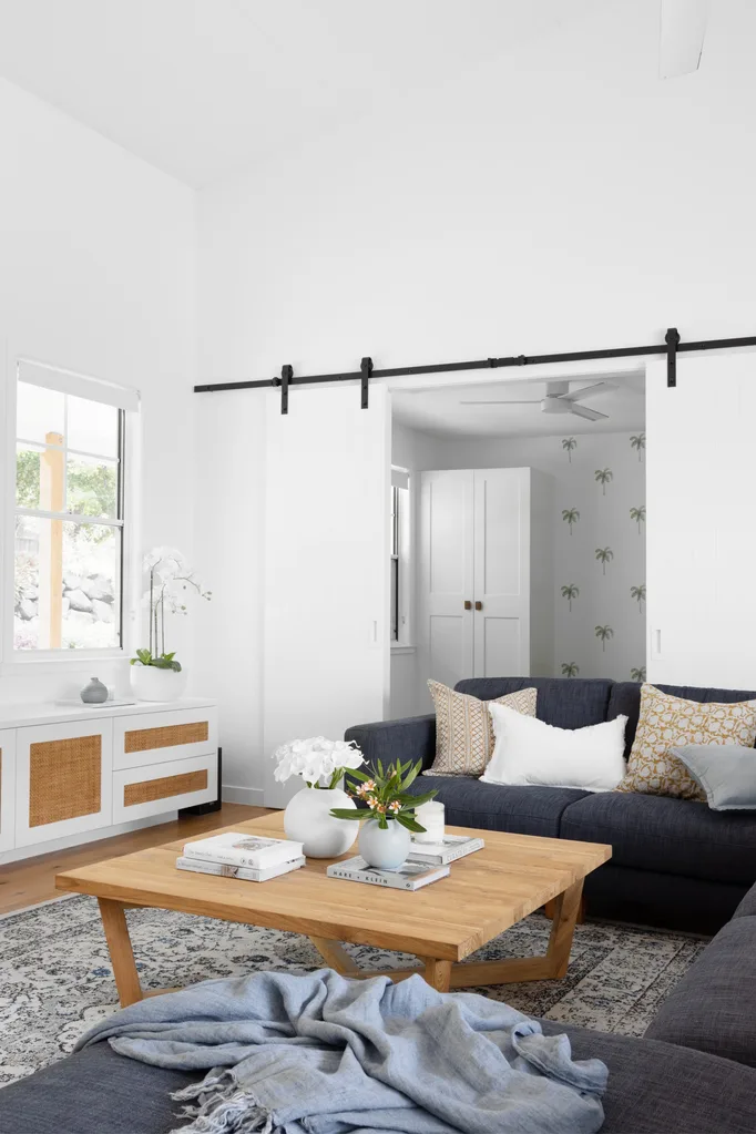 coastal style living room with barn door