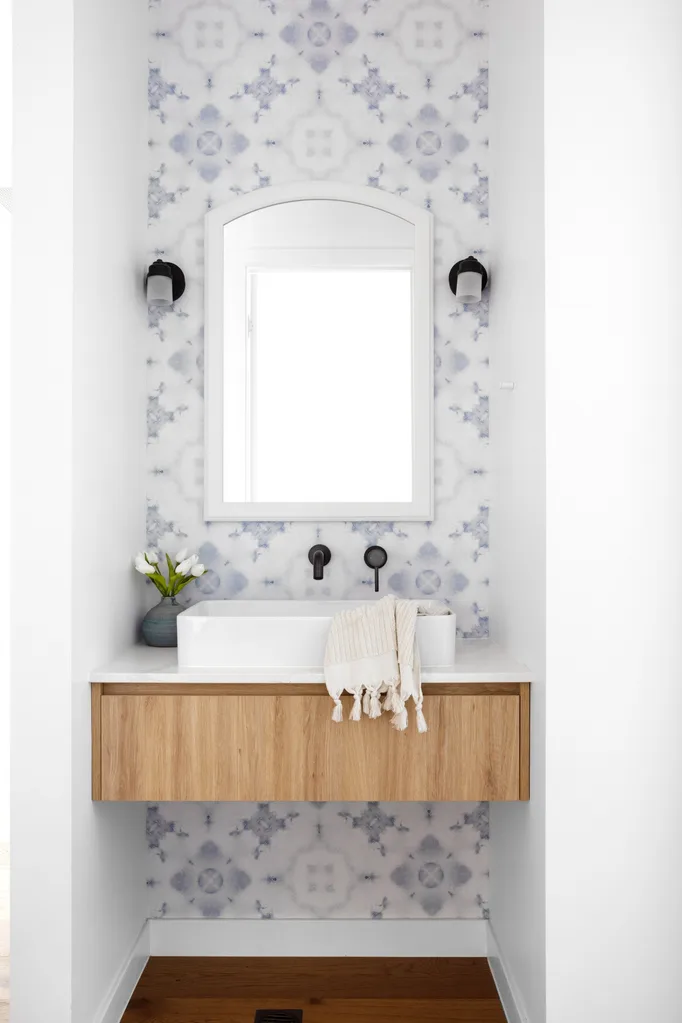 white powder room with pale blue patterned tiles
