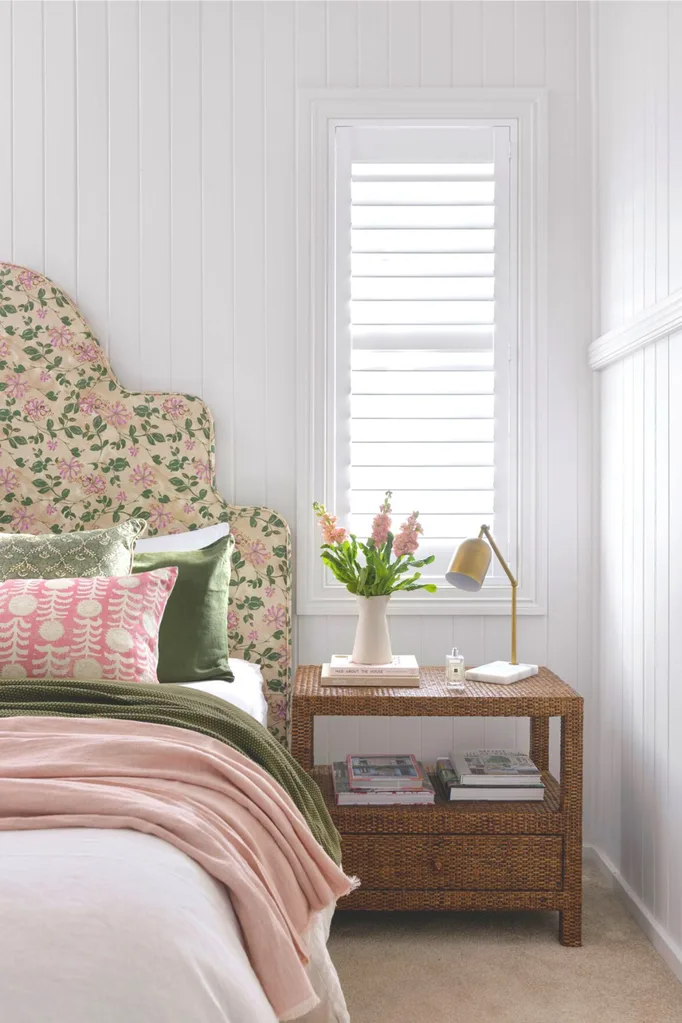 White bedroom with floral upholstered bedhead