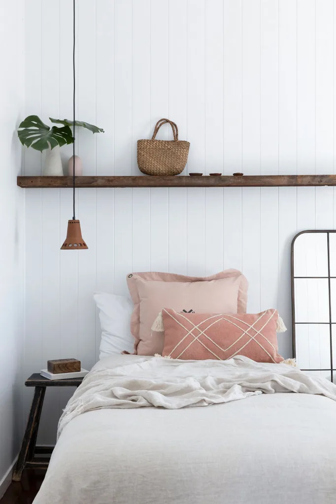 Small bedroom with pendant light and mirror