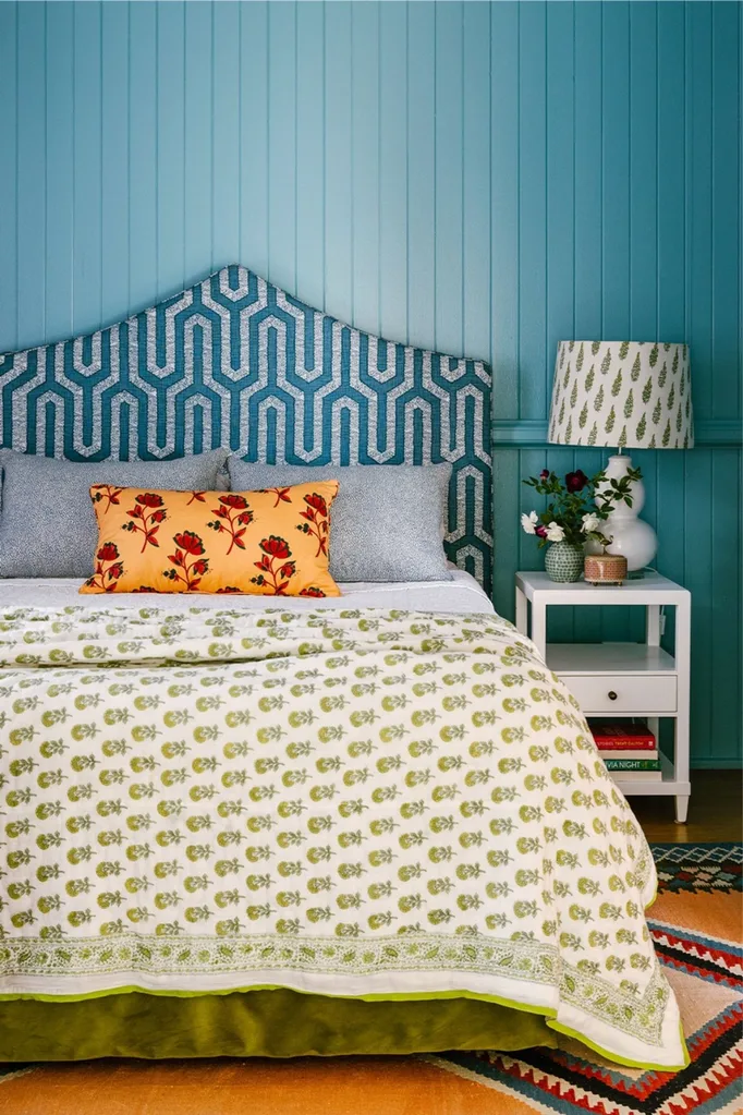 colourful bedroom with patterned bedhead and V-groove panelling