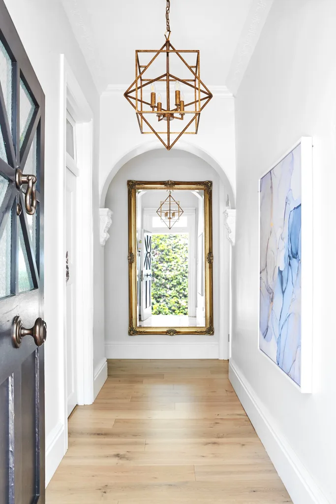 Heritage home hallway with artwork and mirror