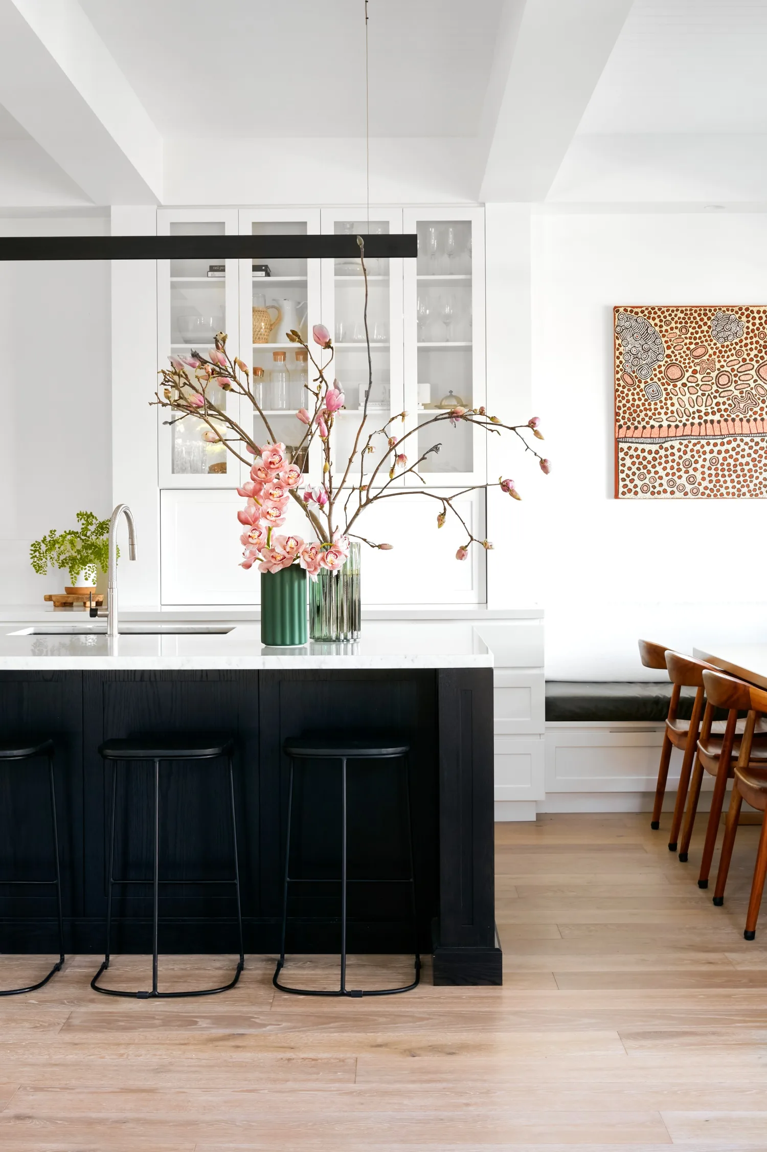 black kitchen island with white marble top