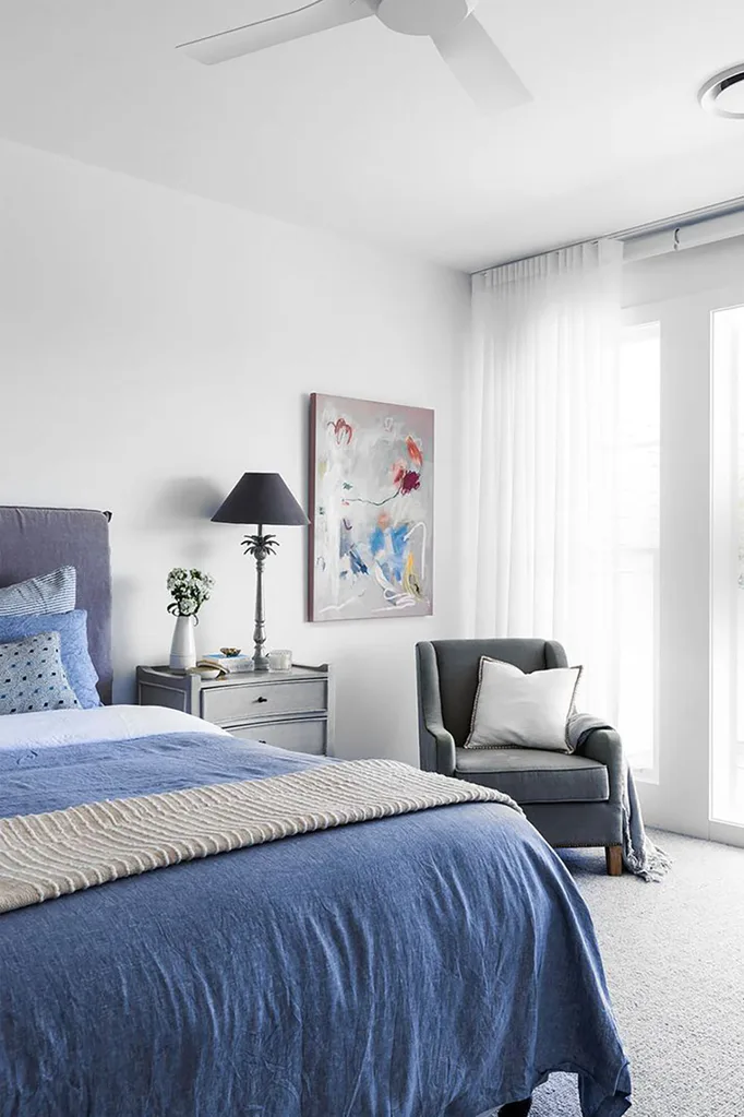 Blue and grey Hamptons bedroom with wall art