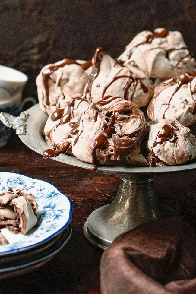 Chocolate meringues placed on a vintage cake stand