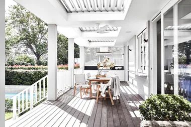 Outdoor dining table on deck with barbeque