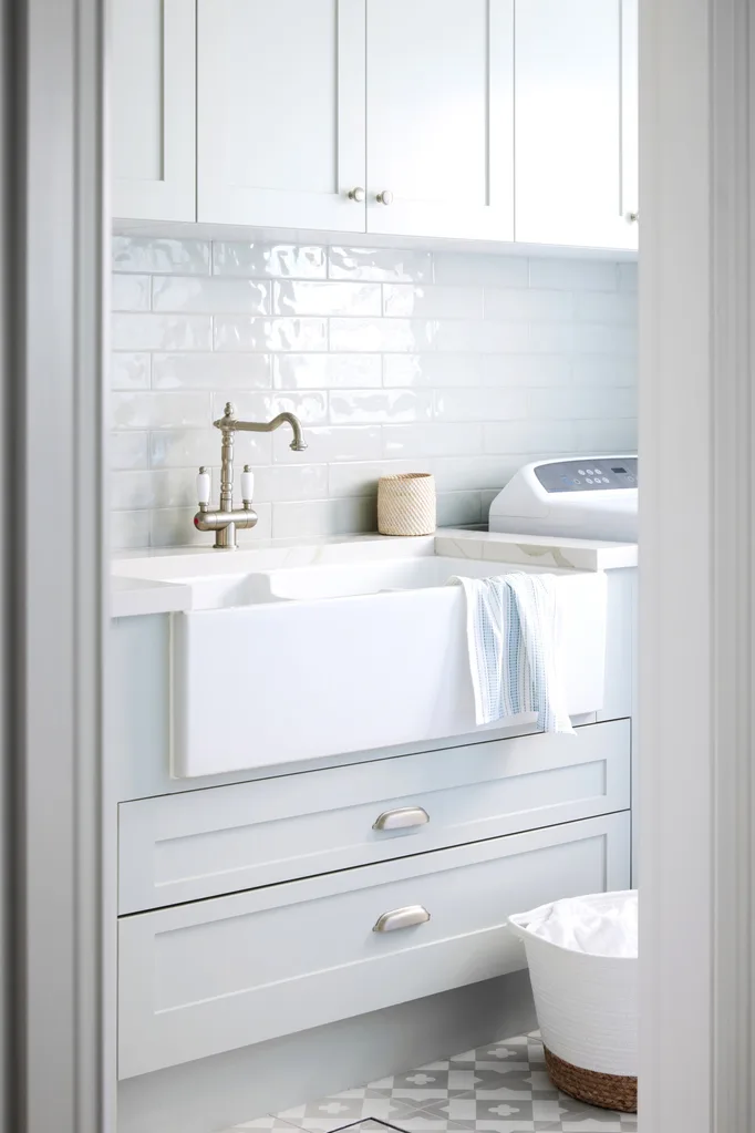 coastal laundry with light grey-green cabinets