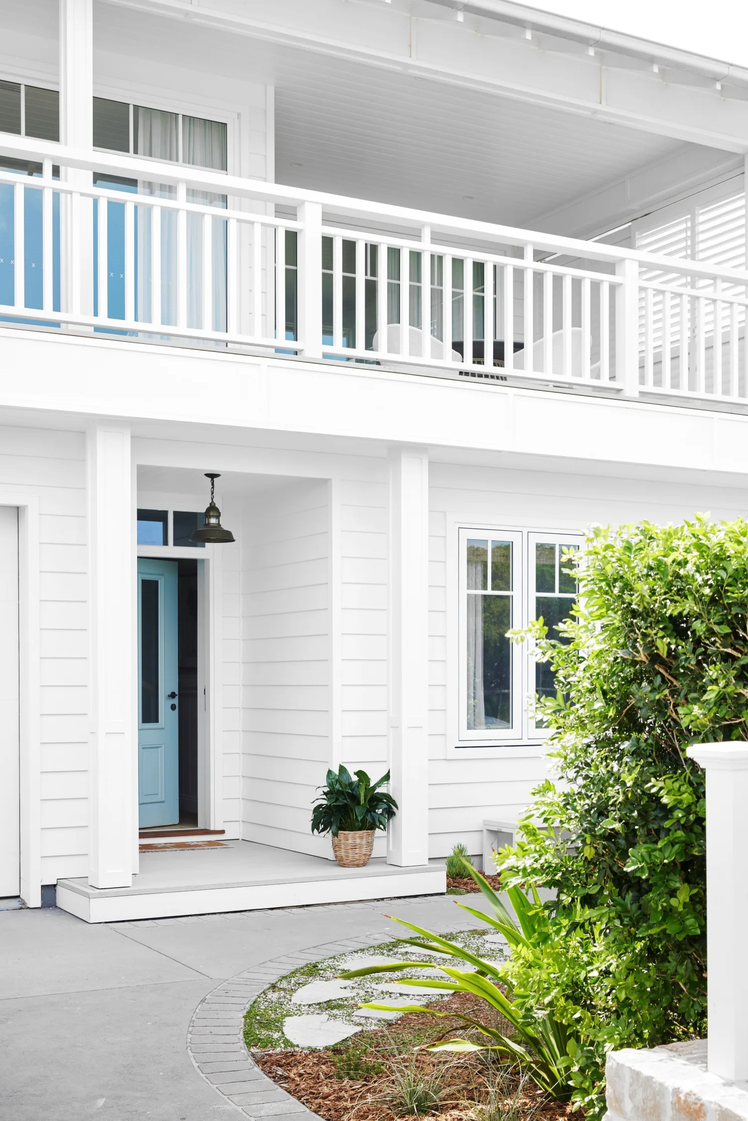 classic coastal white facade with blue front door