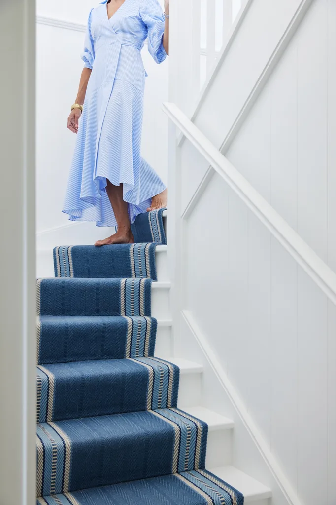 white staircase with blue runner