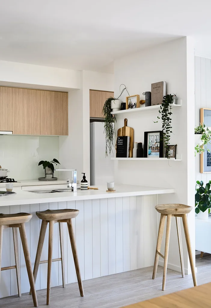 White and timber kitchen with floating shelves on nib wall