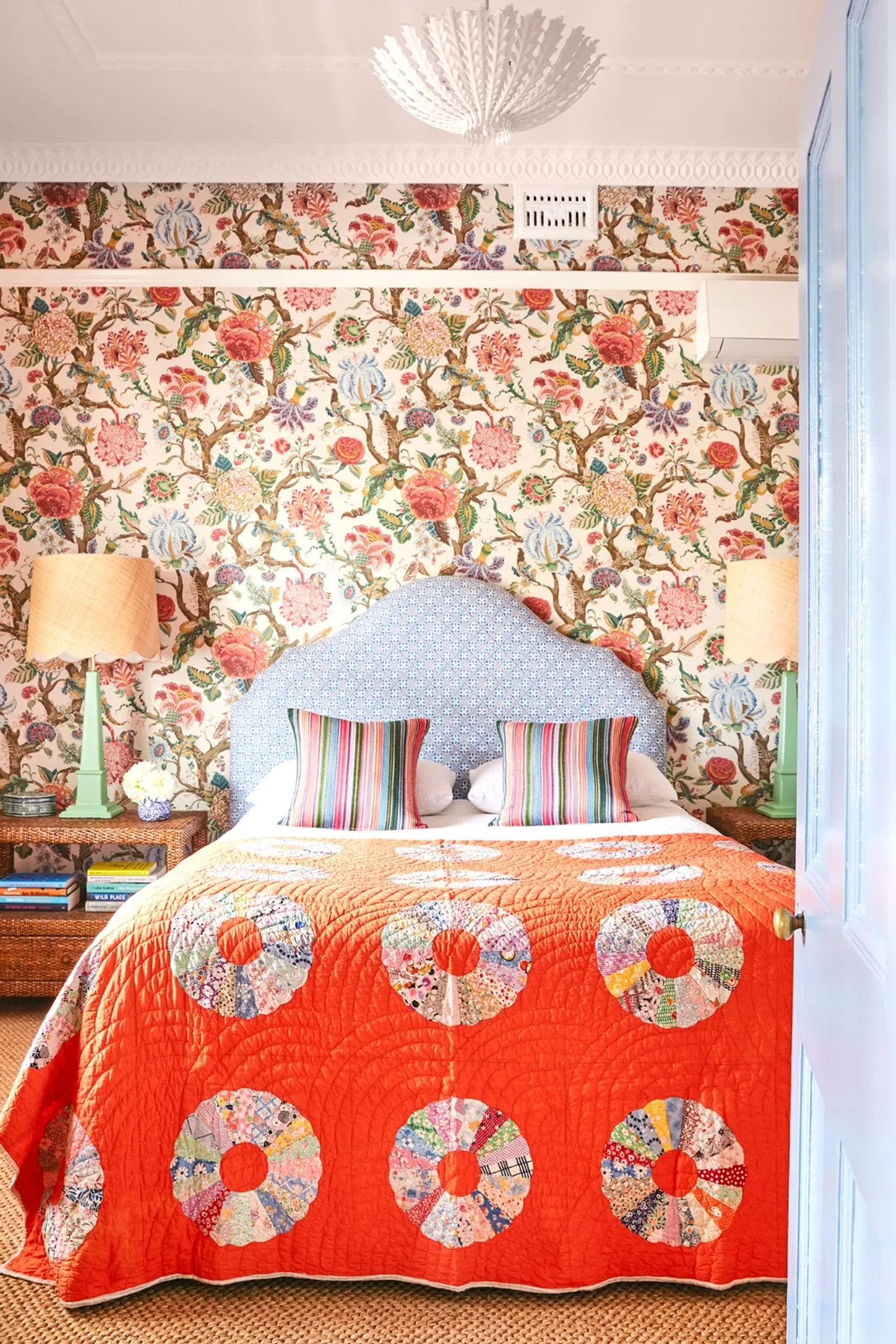 colourful cottage bedroom with bold floral wallpaper