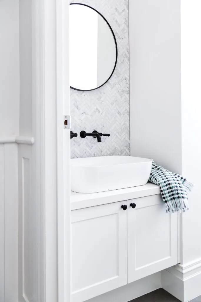 powder room with grey herringbone wall tiles