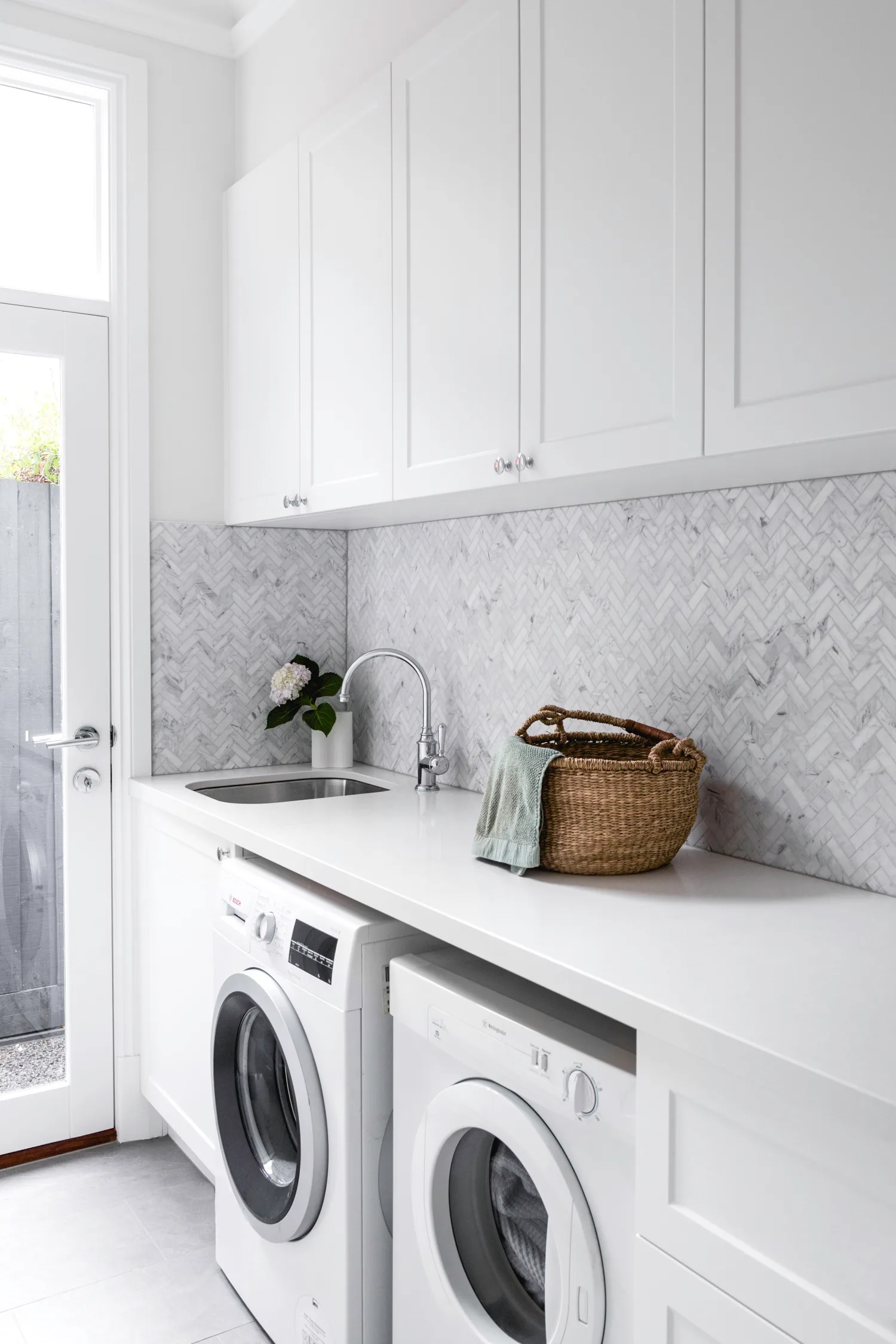 White and marble laundry with shaker cabinets