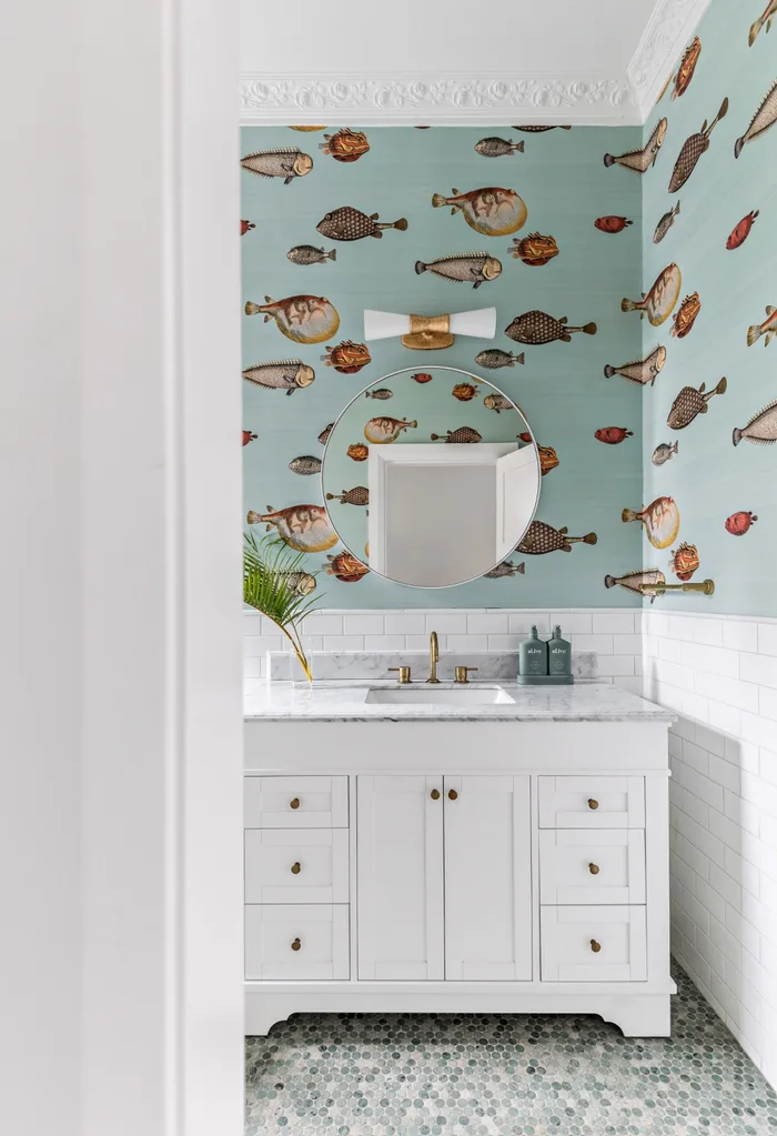 Coastal style bathroom with statement fish wallpaper
