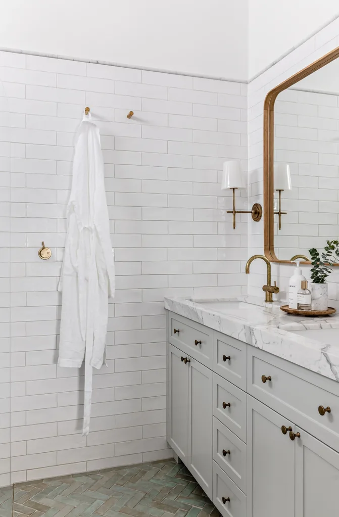 Subtle coastal style bathroom with grey vanity and marble counter