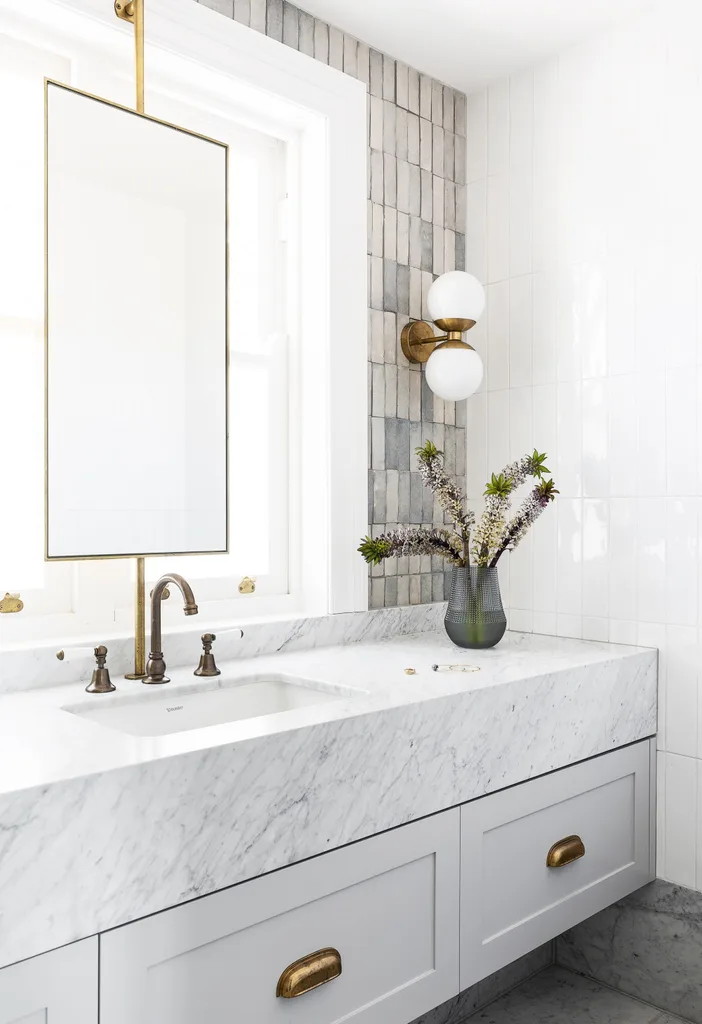 White and blue coastal bathroom with gold tapware