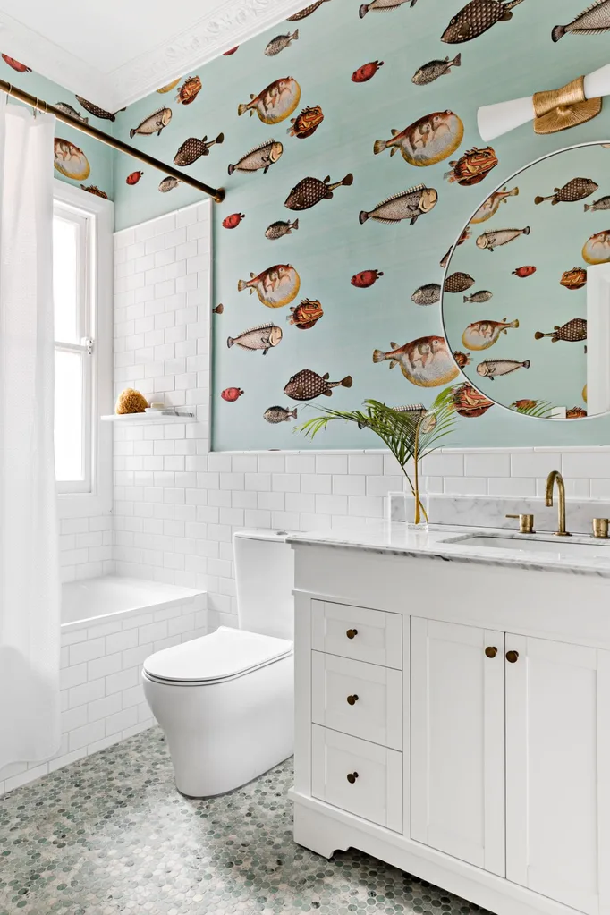 Coastal style bathroom with statement fish wallpaper