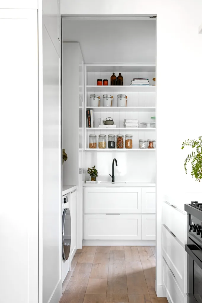 White kitchen with butlers pantry featuring open shelving