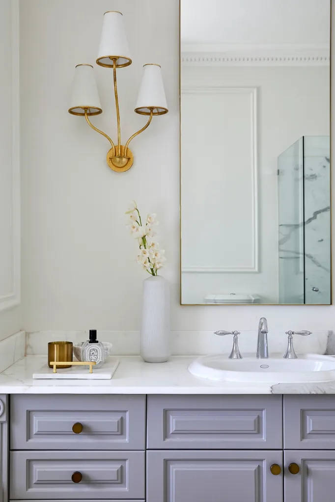 Scented candle on tray in bathroom