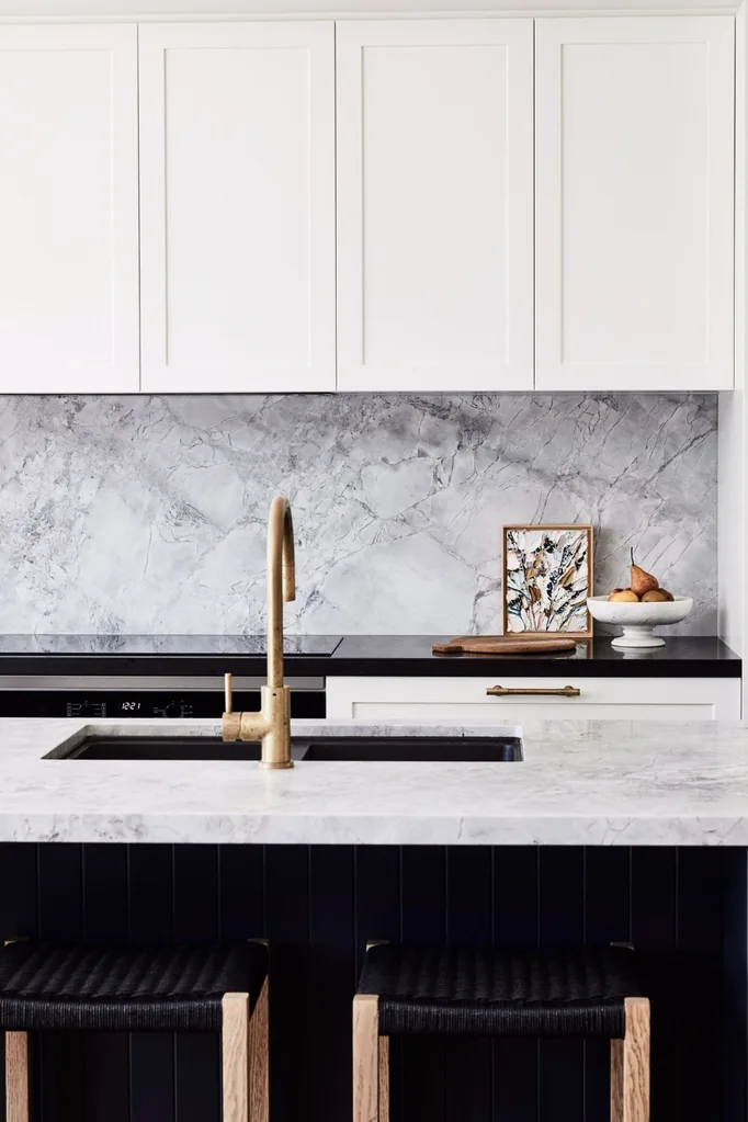 Black and white kitchen with marble benchtop and splashback