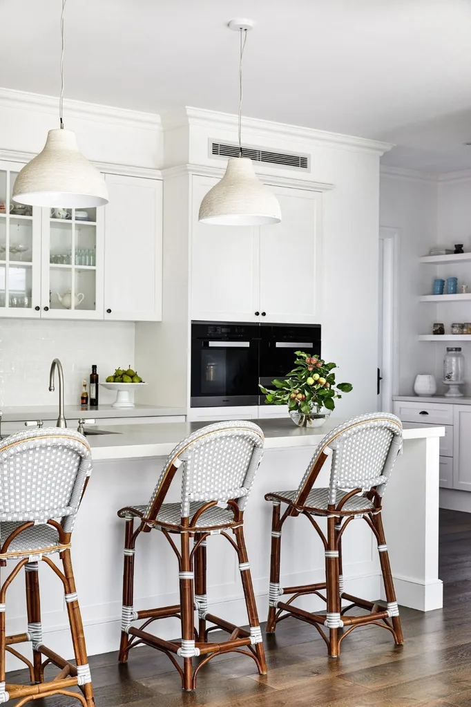 Hamptons kitchen with large pendant lights over kitchen island