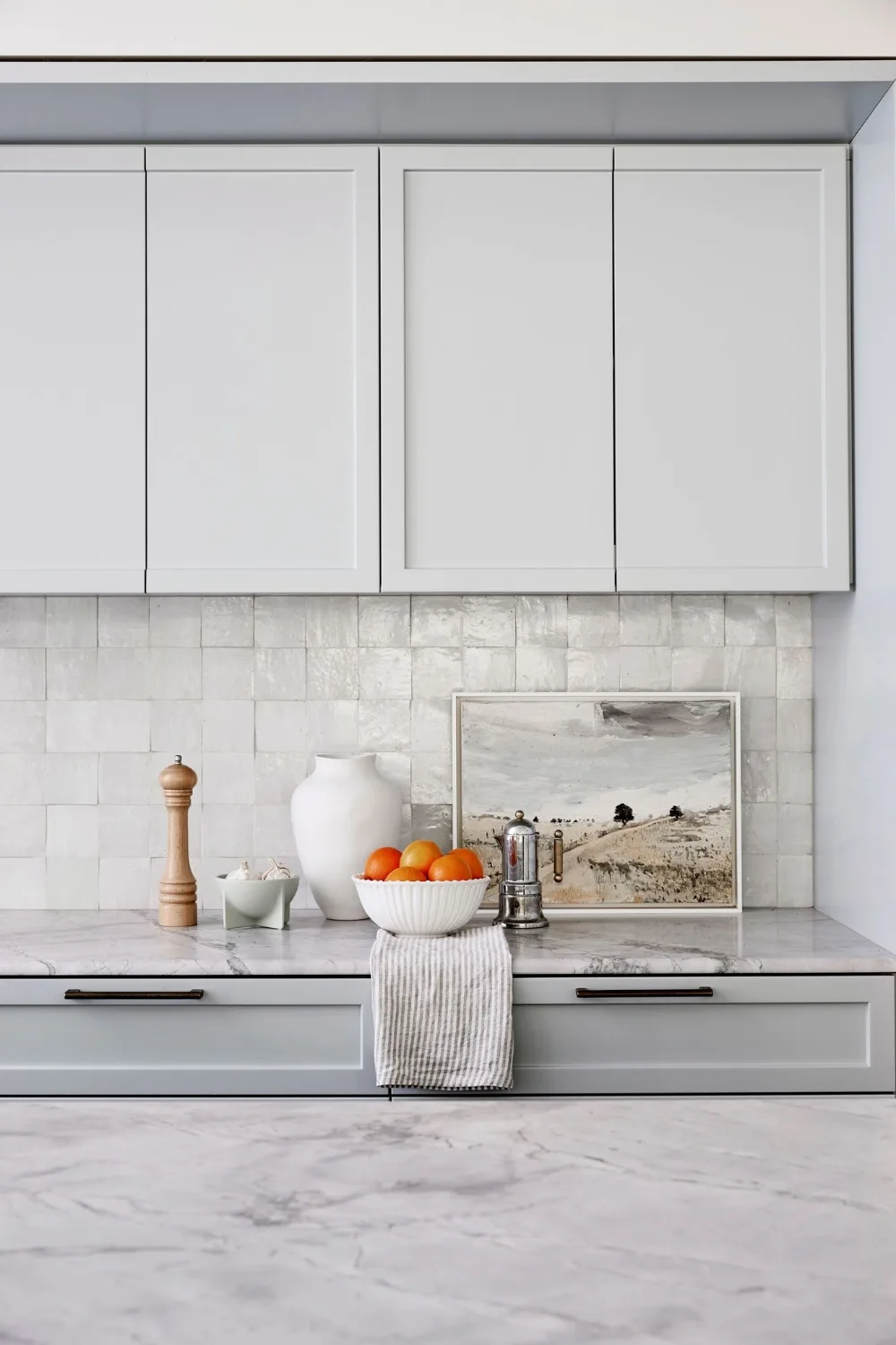 Grey and marble kitchen with square tile splashback