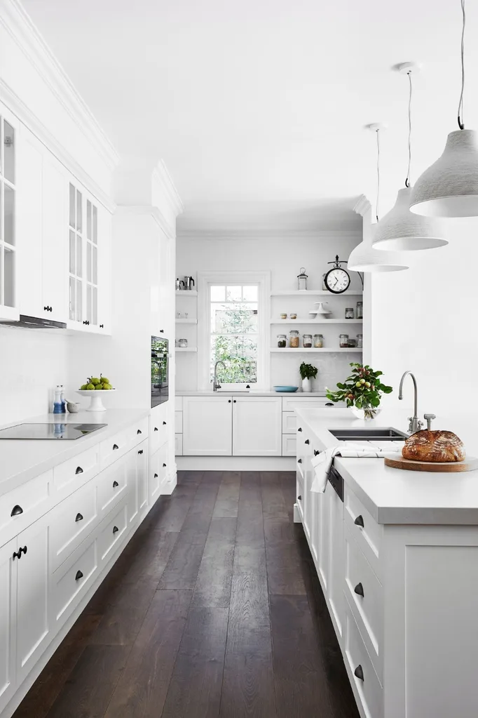 White Hamptons style kitchen with dark flooring