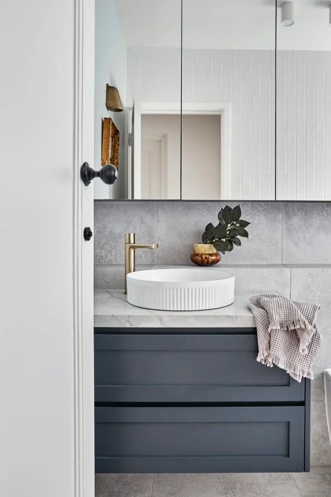 dark grey bathroom vanity with grey tiles