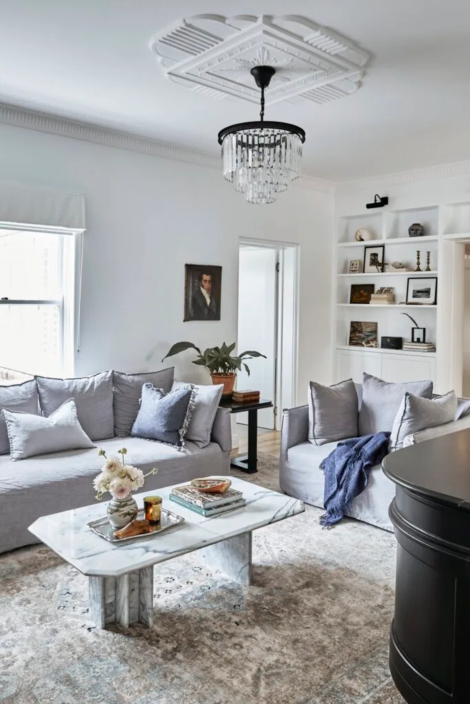 grey lounges with black chandelier