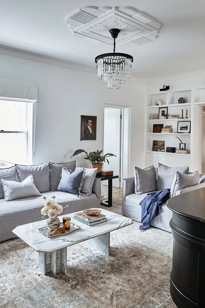 grey lounges with black chandelier