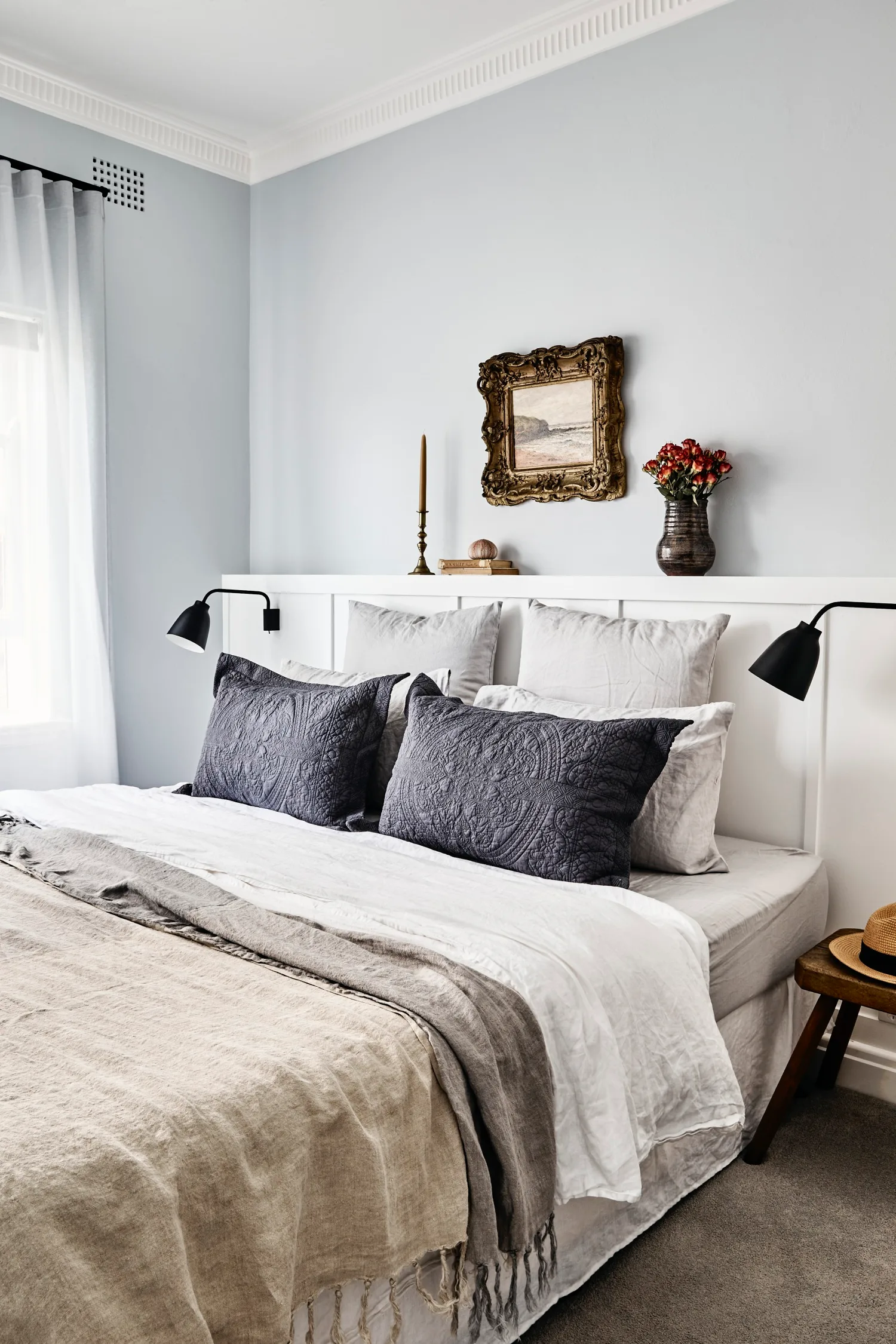 parisian style main bedroom with vintage artwork