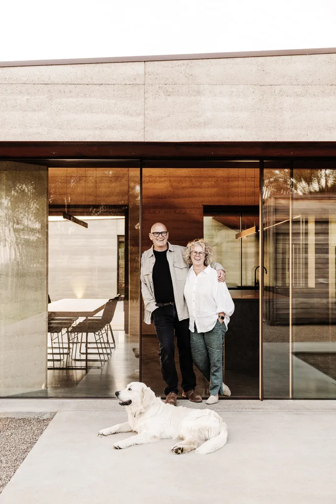 entry with architectural steel archway and sliding glass doors