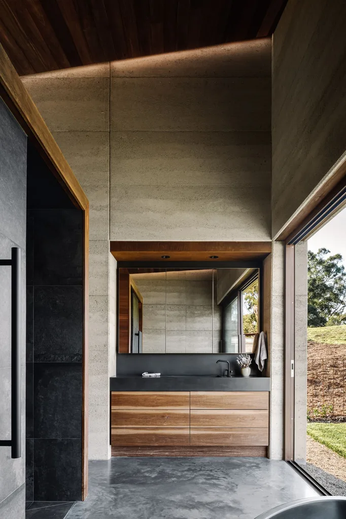 Bathroom with timber cabinetry and polished concrete floors