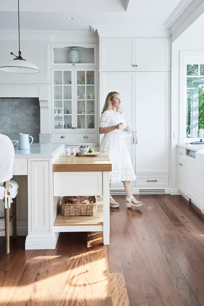 white kitchen cabinetry with wooden floors